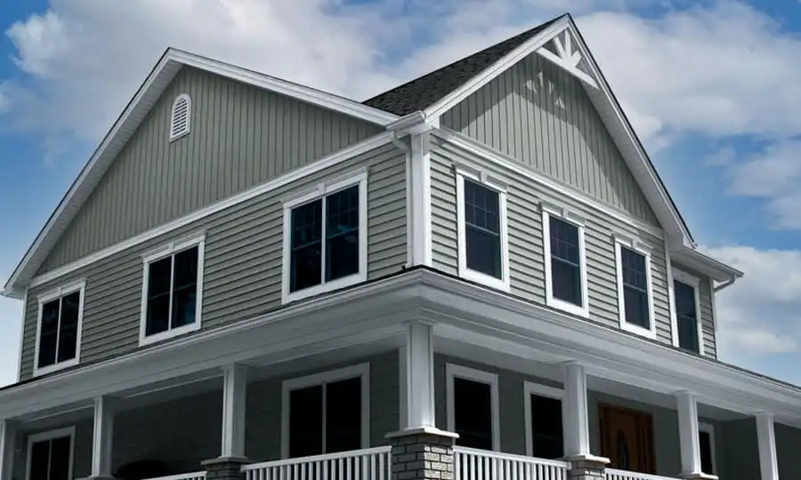 Modern farmhouse exterior with vertical gray siding and white trim