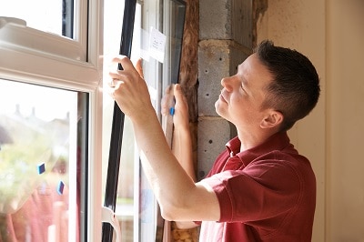 construction worker installing window