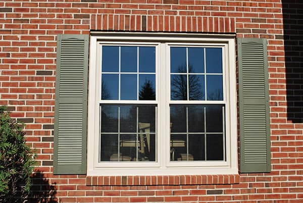 double hung windows on a brick siding wall