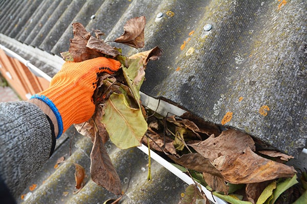 cleaning gutters to prepare for storm season