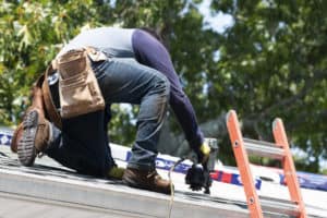a roofing professional working on repair a roof