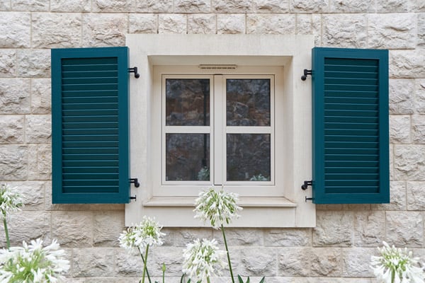 beige window with green shutters
