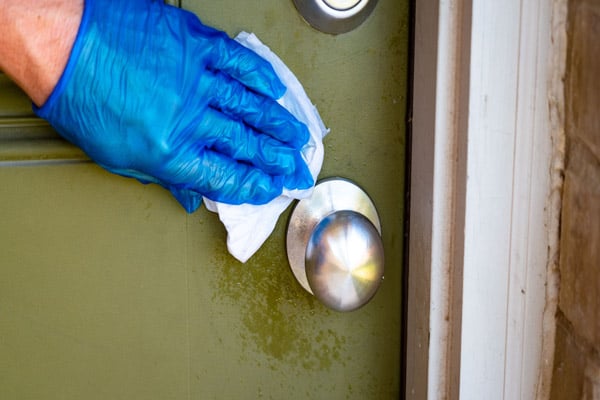 cleaning a green painted door