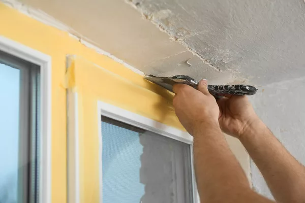 using a putty knife to seal a replacement window